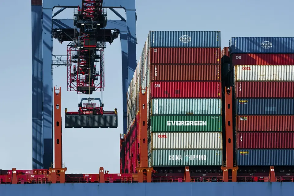 Port crane loading a shipping container